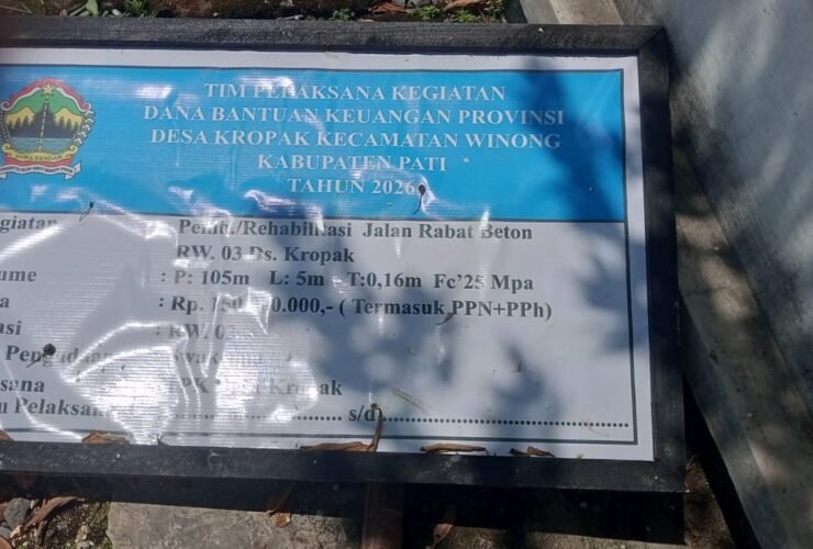 Papan informasi proyek pembangunan jalan beton di Desa Kropak, Kecamatan Winong, Kabupaten Pati. Tertera sumber dana dari Bantuan Keuangan Provinsi Jawa Tengah Tahun 2026 senilai Rp 150.000.000 untuk volume jalan 105m x 5m x 0,16m.